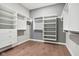 Spacious walk-in closet boasts custom shelving, drawers, and hardwood flooring at 12594 Pasco St, Fishers, IN 46038