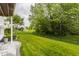 A spacious backyard featuring green grass and mature trees at 13091 Duval Dr, Fishers, IN 46037