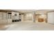 Finished basement with neutral carpet, custom shelves and cabinets at 13091 Duval Dr, Fishers, IN 46037
