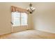 Bright dining room featuring hardwood floors, a large window, and a decorative chandelier at 13091 Duval Dr, Fishers, IN 46037