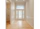 Inviting foyer with decorative front door, wood floors, high ceilings, and wainscoting at 13091 Duval Dr, Fishers, IN 46037