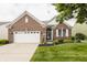 Charming brick home featuring a well-maintained lawn, two-car garage, and manicured landscaping at 13091 Duval Dr, Fishers, IN 46037