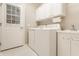Laundry room featuring a washer, dryer, sink, and white cabinets at 13091 Duval Dr, Fishers, IN 46037