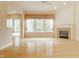 Bright living room featuring a fireplace, hardwood floors, large windows, and a neutral color scheme at 13091 Duval Dr, Fishers, IN 46037