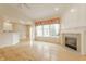 Open living room with hardwood floors, fireplace, and a large window overlooking the backyard at 13091 Duval Dr, Fishers, IN 46037