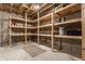 Unfinished basement storage room with wooden shelving and concrete floors at 13091 Duval Dr, Fishers, IN 46037