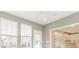 Bright sunroom with tile flooring, ceiling fan and access to kitchen, for cozy relaxation at 13091 Duval Dr, Fishers, IN 46037