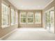 Bright sunroom featuring multiple windows and a sliding door to the deck at 13091 Duval Dr, Fishers, IN 46037