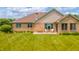 The property has a spacious manicured lawn and a patio with seating at 1324 N Stewart Rd, Anderson, IN 46012
