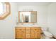 Bright bathroom featuring a double sink vanity, wood cabinets and a window that provides ample light at 1324 N Stewart Rd, Anderson, IN 46012