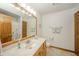 Bathroom with vanity, toilet, mirror, wood-trimmed door, and decorative towels, offering a clean and functional space at 1324 N Stewart Rd, Anderson, IN 46012