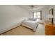 Simple bedroom with a queen-sized bed, natural light from the window, and a dresser at 1324 N Stewart Rd, Anderson, IN 46012