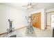 Bedroom with exercise equipment, a ceiling fan, neutral carpet, and closet space at 1324 N Stewart Rd, Anderson, IN 46012