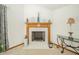 Close-up of a cozy fireplace featuring a decorative mantel, tiled hearth, and stylish accessories at 1324 N Stewart Rd, Anderson, IN 46012