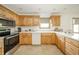 Bright kitchen with light wooden cabinets, stainless appliances, and a peninsula with seating at 1324 N Stewart Rd, Anderson, IN 46012