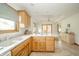 Kitchen with light wooden cabinets and a breakfast bar overlooking the bright dining room at 1324 N Stewart Rd, Anderson, IN 46012