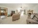 Spacious living room with plush seating, a fireplace, and a view into the adjoining kitchen and office area at 1324 N Stewart Rd, Anderson, IN 46012
