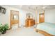 Bright main bedroom showcasing a four-poster bed, a large dresser, and an ensuite bathroom at 1324 N Stewart Rd, Anderson, IN 46012