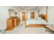 Luxurious main bedroom with a four-poster bed, a dresser with a mirror, and plush carpeting at 1324 N Stewart Rd, Anderson, IN 46012