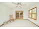Inviting sunroom with neutral carpeting, ample natural light, ceiling fan, and a comfortable rocking chair at 1324 N Stewart Rd, Anderson, IN 46012