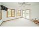 Bright sunroom featuring white walls, neutral carpeting, and natural light from the windows and glass panel door at 1324 N Stewart Rd, Anderson, IN 46012