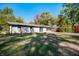 Spacious backyard with a white house and vibrant fall foliage, providing a private outdoor retreat at 1325 Alimingo Dr, Indianapolis, IN 46260