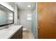 Well-lit bathroom featuring a dark vanity, decorative mirror and stylish fixtures, offering a serene space at 1325 Alimingo Dr, Indianapolis, IN 46260