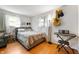 Bright bedroom featuring hardwood floors, a comfortable bed, and natural light at 1325 Alimingo Dr, Indianapolis, IN 46260