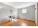 Spacious bedroom with hardwood floors, neutral walls, and a classic writing desk at 1325 Alimingo Dr, Indianapolis, IN 46260