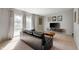 Bright living room with large windows, a modern console, and comfortable seating at 1325 Alimingo Dr, Indianapolis, IN 46260