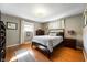 Serene main bedroom with hardwood floors, a comfortable bed, and ample natural light at 1325 Alimingo Dr, Indianapolis, IN 46260