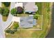 Aerial view of a house showcasing its backyard, proximity to a pond, and surrounding greenery at 1412 Huntzinger Blvd, Pendleton, IN 46064