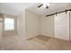 Bedroom featuring neutral carpet, ceiling fan and sliding barn door to closet at 1412 Huntzinger Blvd, Pendleton, IN 46064