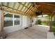 The covered patio has a TV, ceiling fan, and ample space for outdoor living at 1412 Huntzinger Blvd, Pendleton, IN 46064