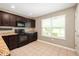 Functional kitchen with wood cabinetry, granite countertops, updated appliances, and tile flooring at 1412 Huntzinger Blvd, Pendleton, IN 46064