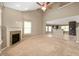 Open-concept living room featuring high ceilings, fireplace, and view into the kitchen with tiled floors at 1412 Huntzinger Blvd, Pendleton, IN 46064