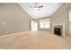 Bright living room with a fireplace, neutral walls, and ample natural light coming from the backyard at 1412 Huntzinger Blvd, Pendleton, IN 46064