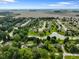 Scenic aerial shot of a quiet neighborhood, featuring tree-lined streets and a central pond at 1506 Bowman Dr, Greenfield, IN 46140