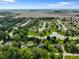 Picturesque community aerial view featuring a tranquil pond, lush greenery, and a sprawling neighborhood at 1506 Bowman Dr, Greenfield, IN 46140