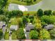 Stunning aerial view highlights the property with a bordering red line, lush trees, and a beautiful pond nearby at 1506 Bowman Dr, Greenfield, IN 46140