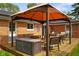 Relaxing backyard featuring a covered patio, wooden deck, and charming outdoor decor at 1506 Bowman Dr, Greenfield, IN 46140