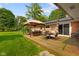 Inviting backyard with wooden deck, gazebo, and landscaped lawn ideal for outdoor enjoyment at 1506 Bowman Dr, Greenfield, IN 46140