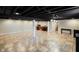 Spacious basement featuring a black painted open ceiling, and light tile flooring at 1506 Bowman Dr, Greenfield, IN 46140