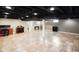Finished basement with neutral walls, tile flooring, and open layout perfect for entertaining at 1506 Bowman Dr, Greenfield, IN 46140