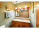 Updated bathroom vanity with granite countertops, unique lighting fixture, and a framed mirror at 1506 Bowman Dr, Greenfield, IN 46140