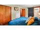 A cozy bedroom featuring wood floors, a closet, and bathroom entrance with sliding barn door at 1506 Bowman Dr, Greenfield, IN 46140