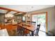 Dining area adjacent to living room, featuring a fireplace and access to the outdoor patio at 1506 Bowman Dr, Greenfield, IN 46140
