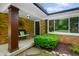 Inviting front porch with bench seating, brick facade, and decorative wall art at 1506 Bowman Dr, Greenfield, IN 46140