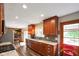 Modern kitchen with stainless steel appliances, granite countertops, and wood cabinets at 1506 Bowman Dr, Greenfield, IN 46140