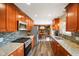 Updated kitchen with stainless steel appliances, granite counters and colorful backsplash at 1506 Bowman Dr, Greenfield, IN 46140